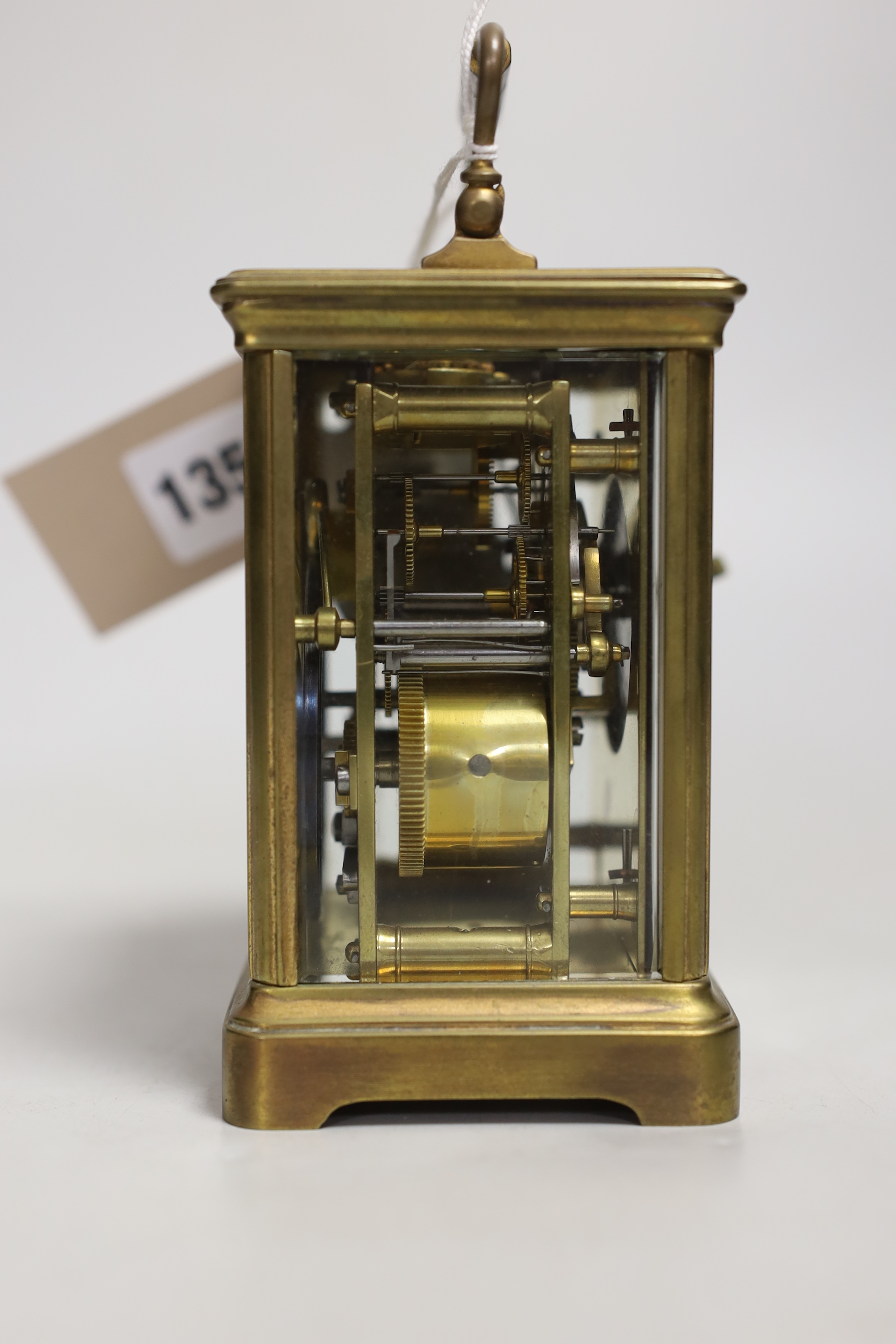 A brass carriage clock and a silver watch, clock 12cm high